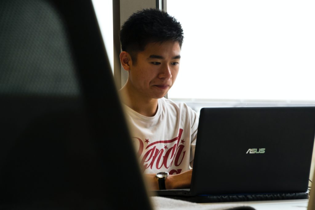 a guy working using an asus laptop